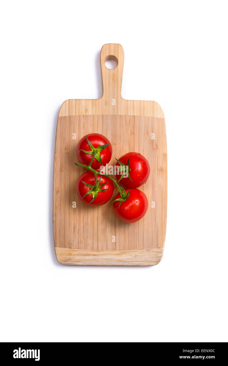 Top view of fresh tomatoes on chopping board isolated on white ...