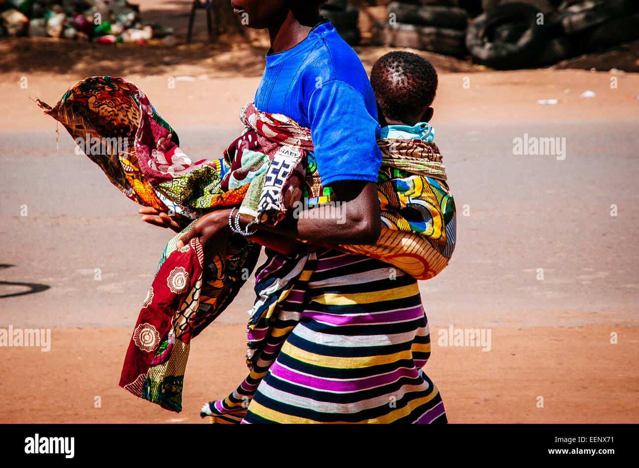 Woman walking while carrying baby on back, Burkina Faso Stock Photo Alamy