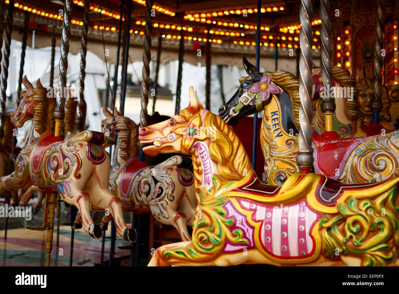 Wooden horses on an old fashioned fairground merry go round or carousel in the UK Stock Photo