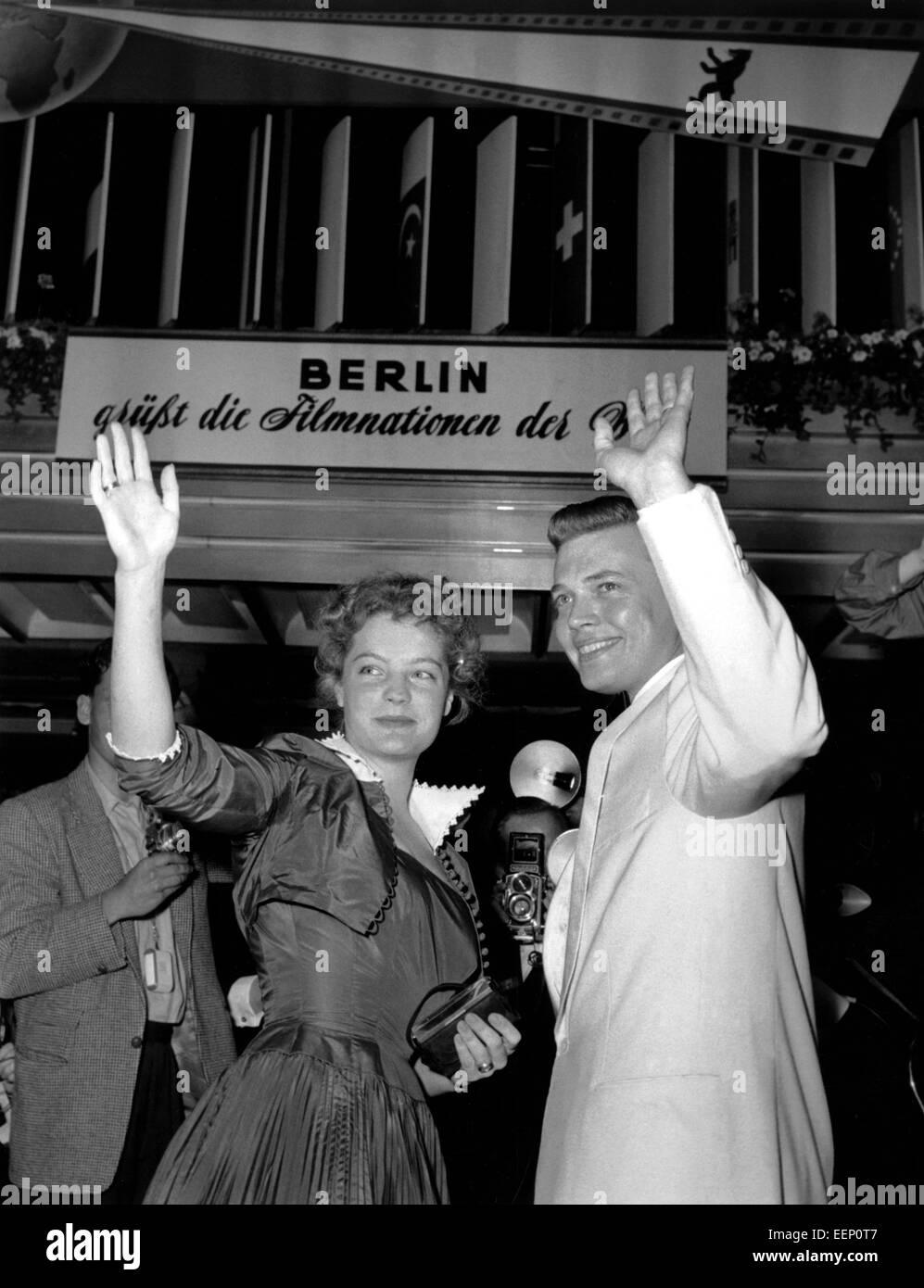 A picture of the beginnings of the Berlinale: Actress Romy Schneider and actor Karlheinz Böhm wave at the opening ceremony of the 5th International film Festival in June 1955 in Berlin. Stock Photo