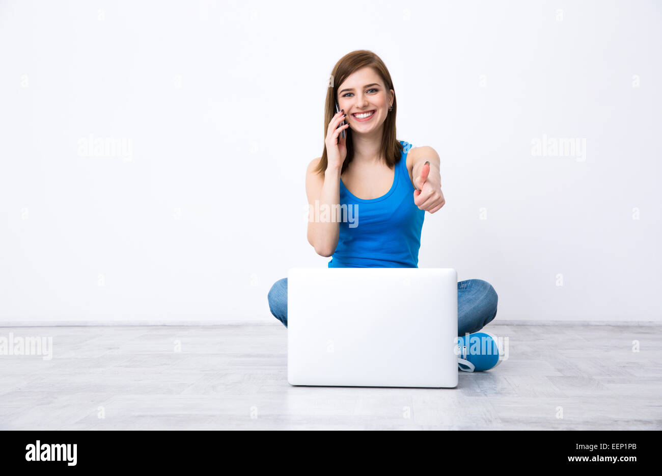 Smiling young woman showing thumb hi-res stock photography and images ...