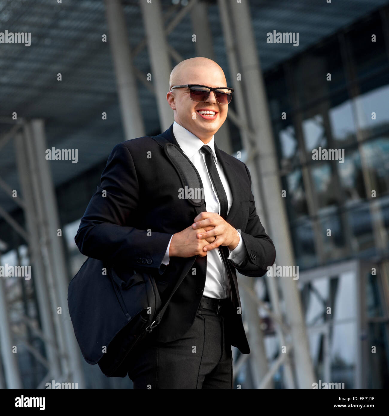 Businessman or banker working outside the airport or contemporary building Stock Photo