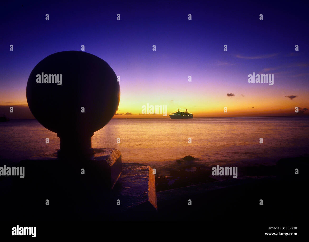 A cruise ship on the horizon at dusk viewed from Cozumel. Mexico Stock Photo