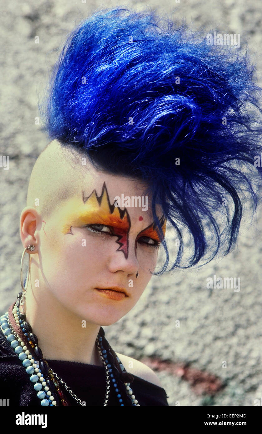 A teenage girl punk rocker with dyed blue hair in a mohican style. London. Circa 1980's Stock Photo