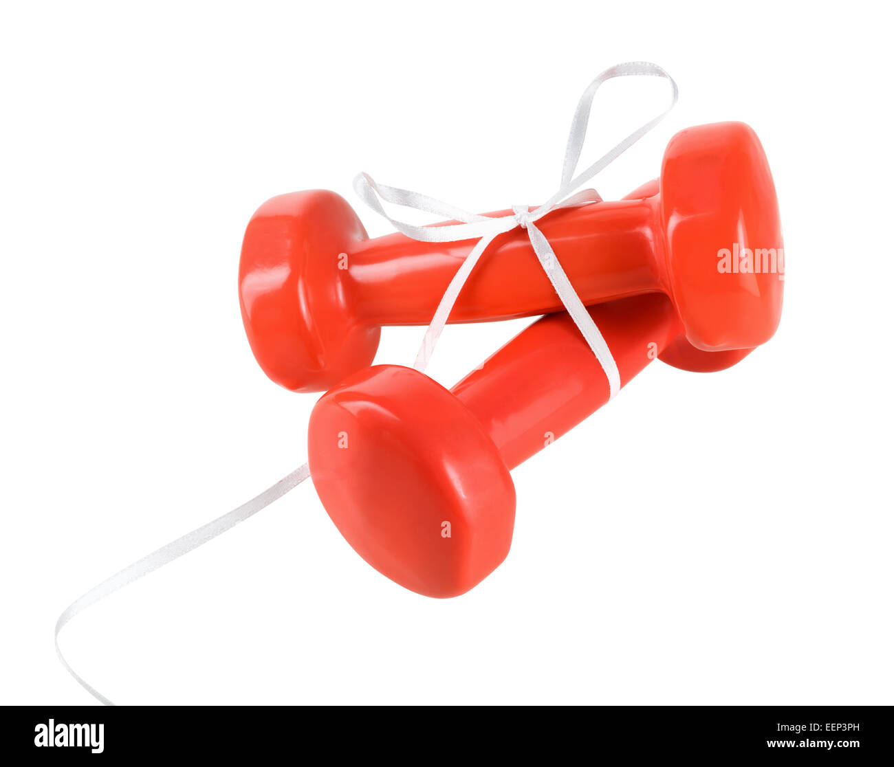 Two dumbbells with rubber coated red, tied with white satin ribbon with a bow on a white background. Isolated with clipping path Stock Photo