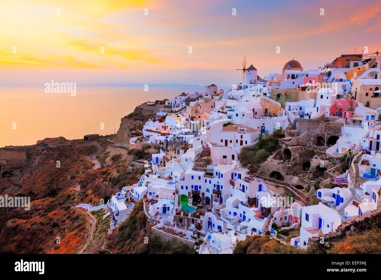 Vibrant sunset over houses and villas at Oia Santorini Greece Stock Photo