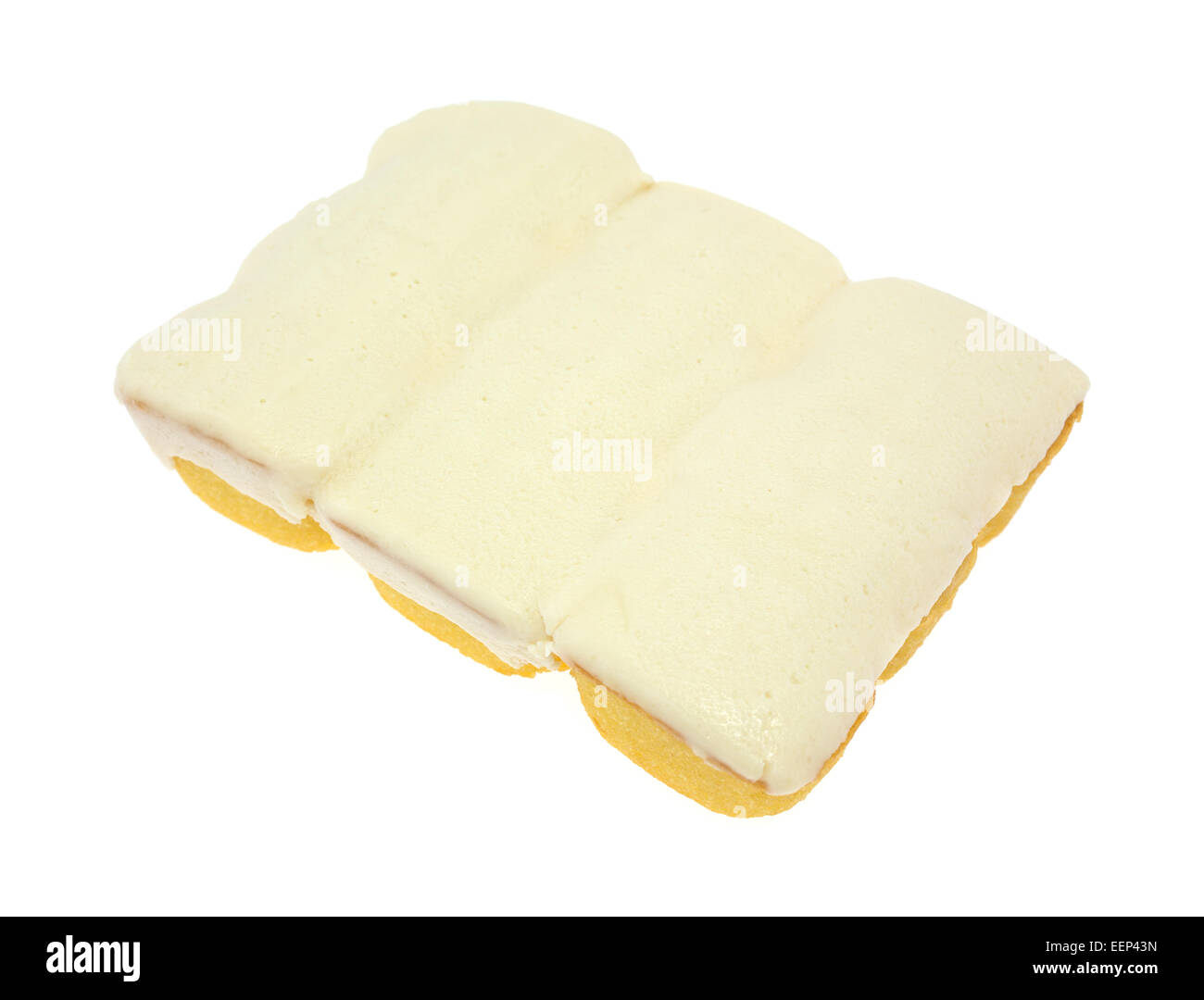 Three bite size yellow snack cakes with vanilla icing on a white