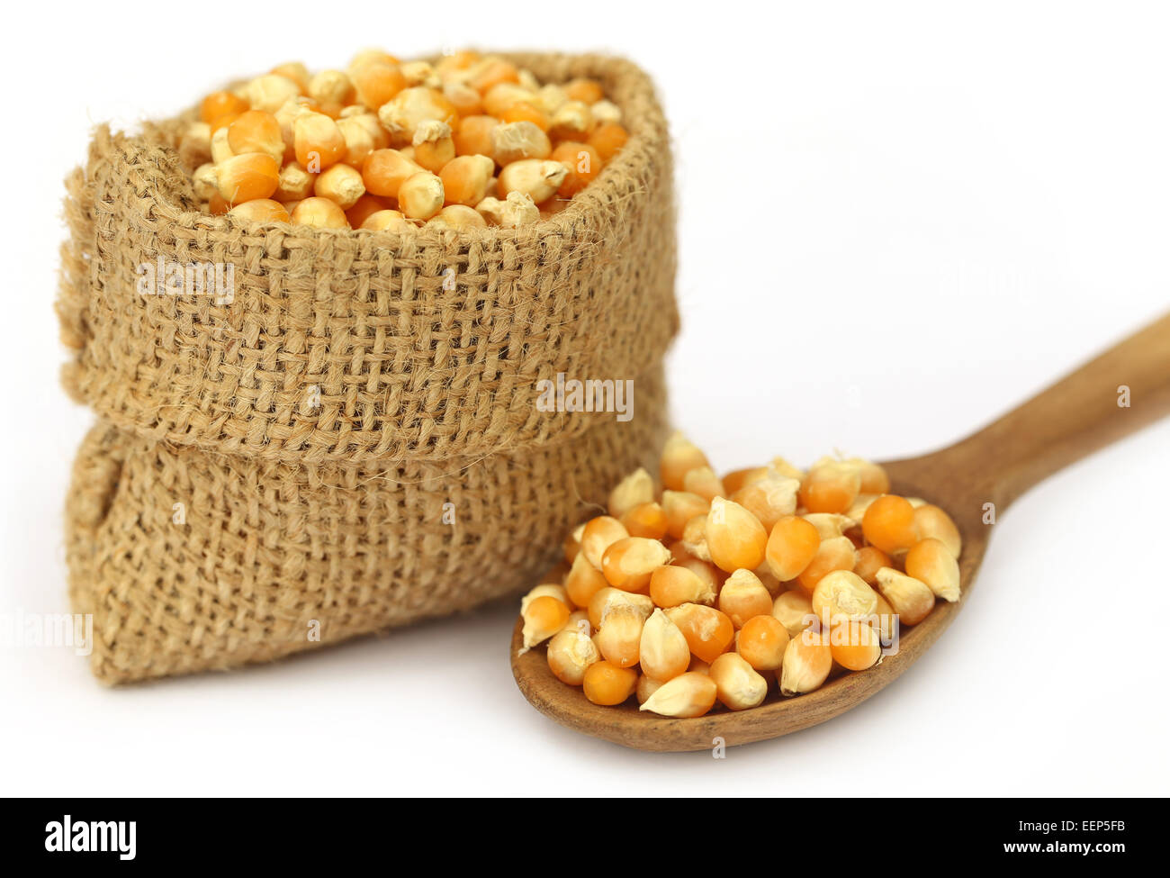 Corns in sack bag with spoon over white background Stock Photo - Alamy
