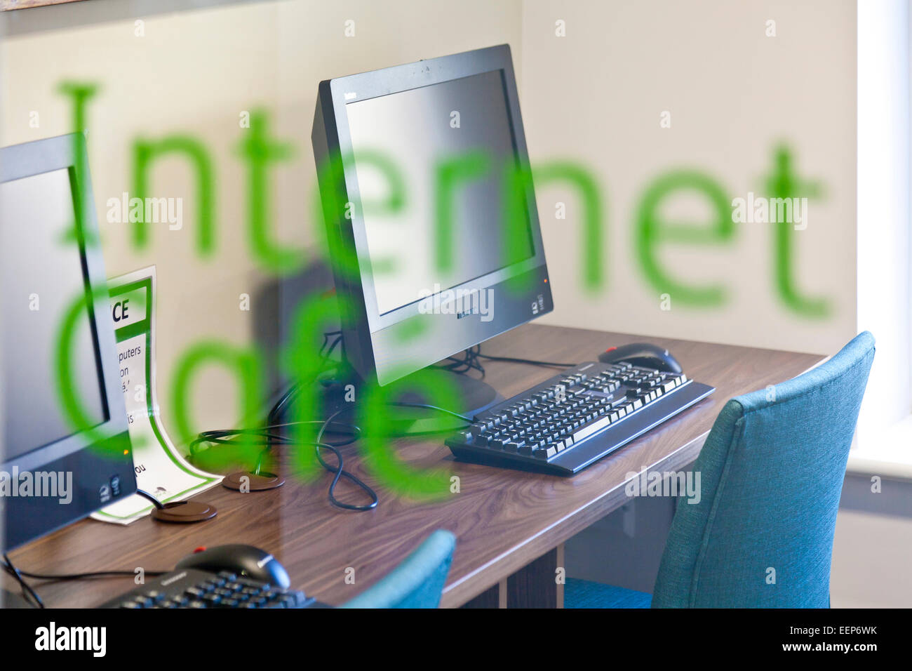 View of Internet cafe through sign on window Stock Photo