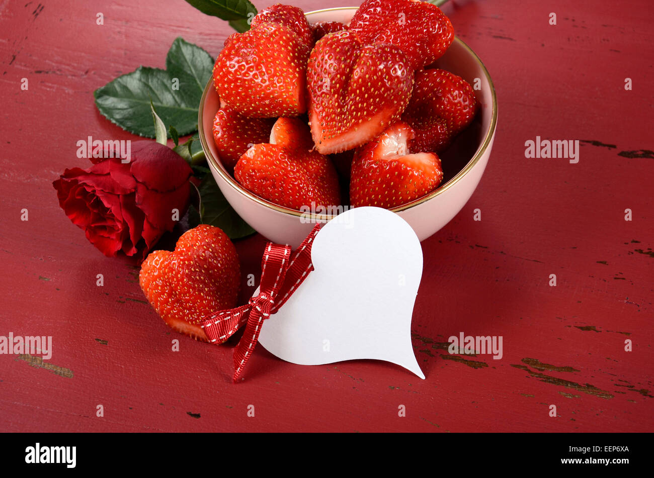 Happy Valentines Day bowl of luscious heart shape red strawberries on a ...