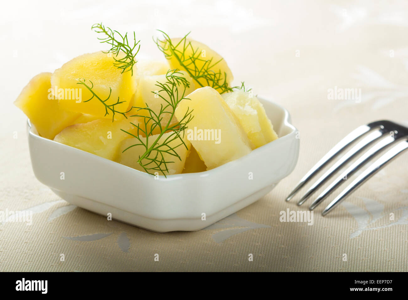 Fresh boiled potatoes with dill and fork Stock Photo