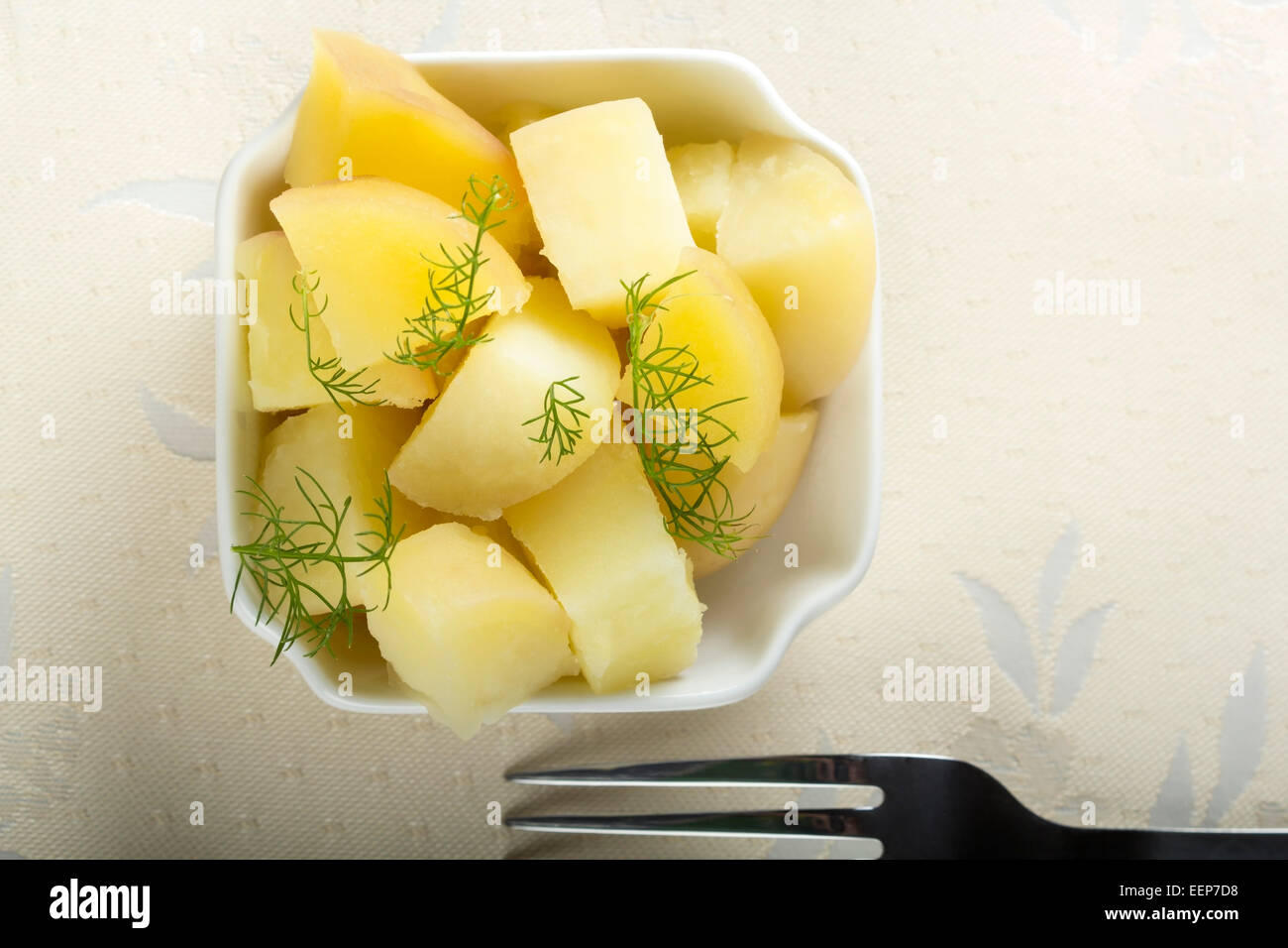 Fresh boiled potatoes with dill and fork Stock Photo