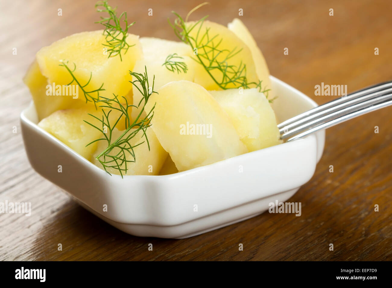 Fresh boiled potatoes with dill and fork Stock Photo