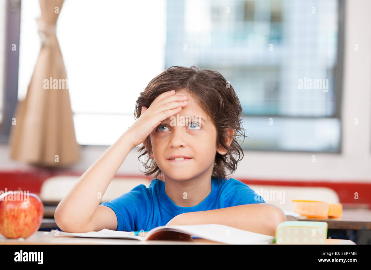 Student at elementary school thinking about problem solving. Stock Photo