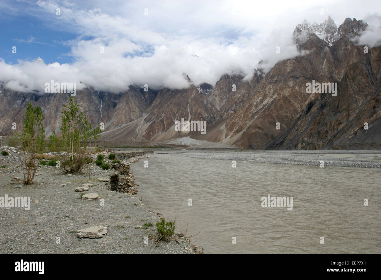 river along the KKH in Pakistan and clouds hiding high mountains Stock Photo