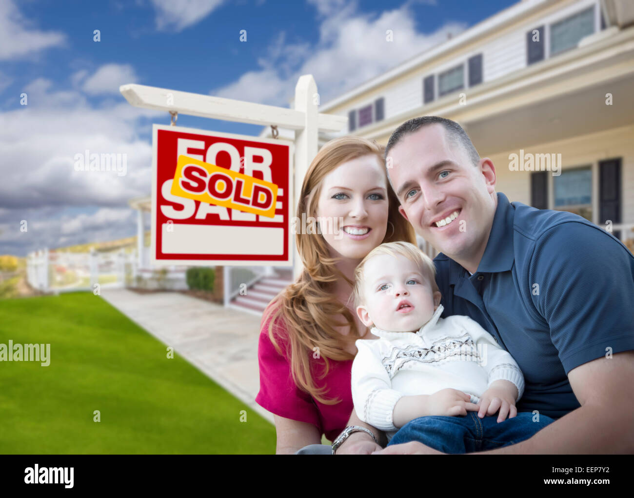 Happy Young Military Family in Front of Sold Real Estate Sign and New ...
