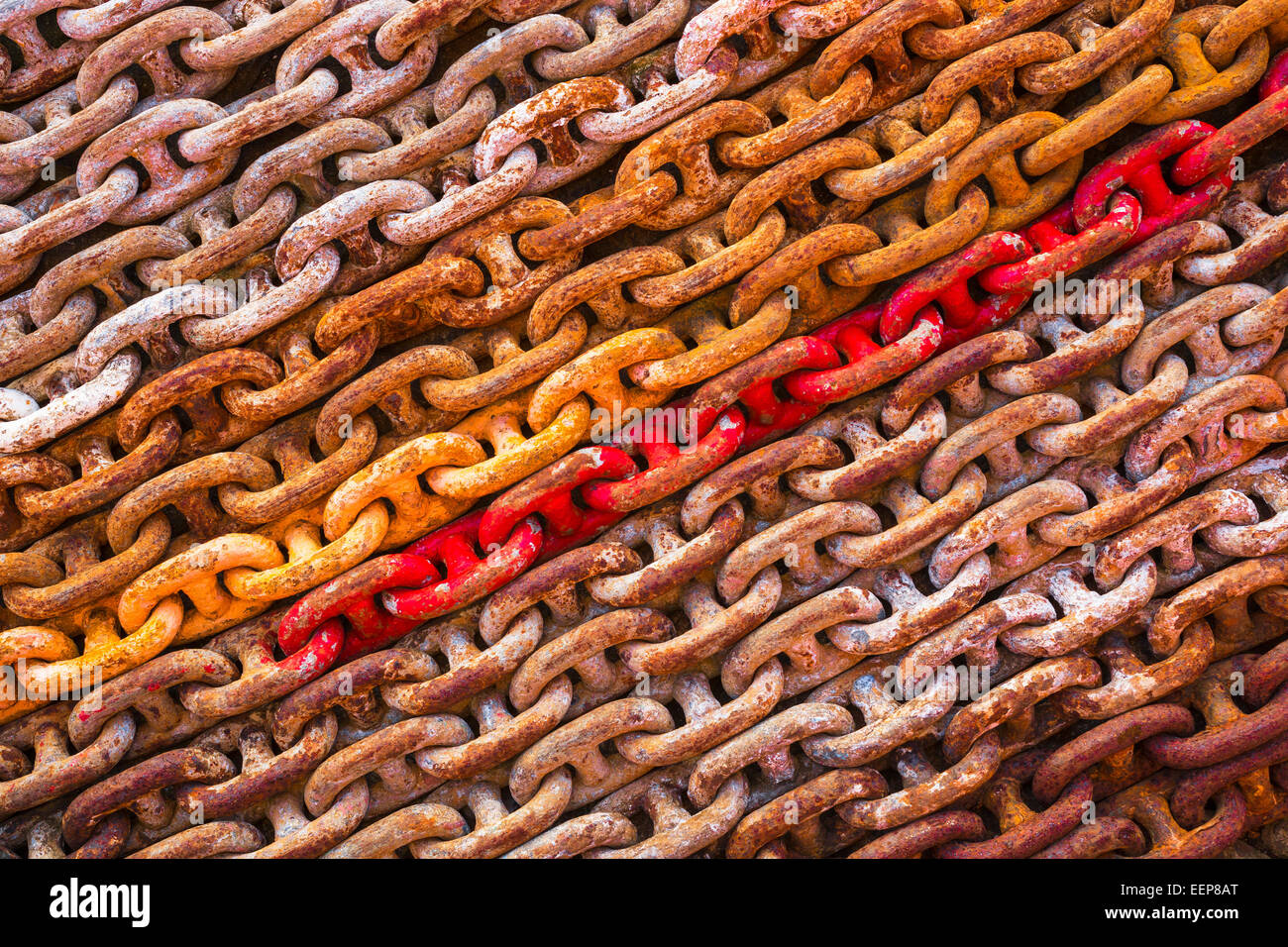 Multicoloured chains in an engineering workshop. Stock Photo
