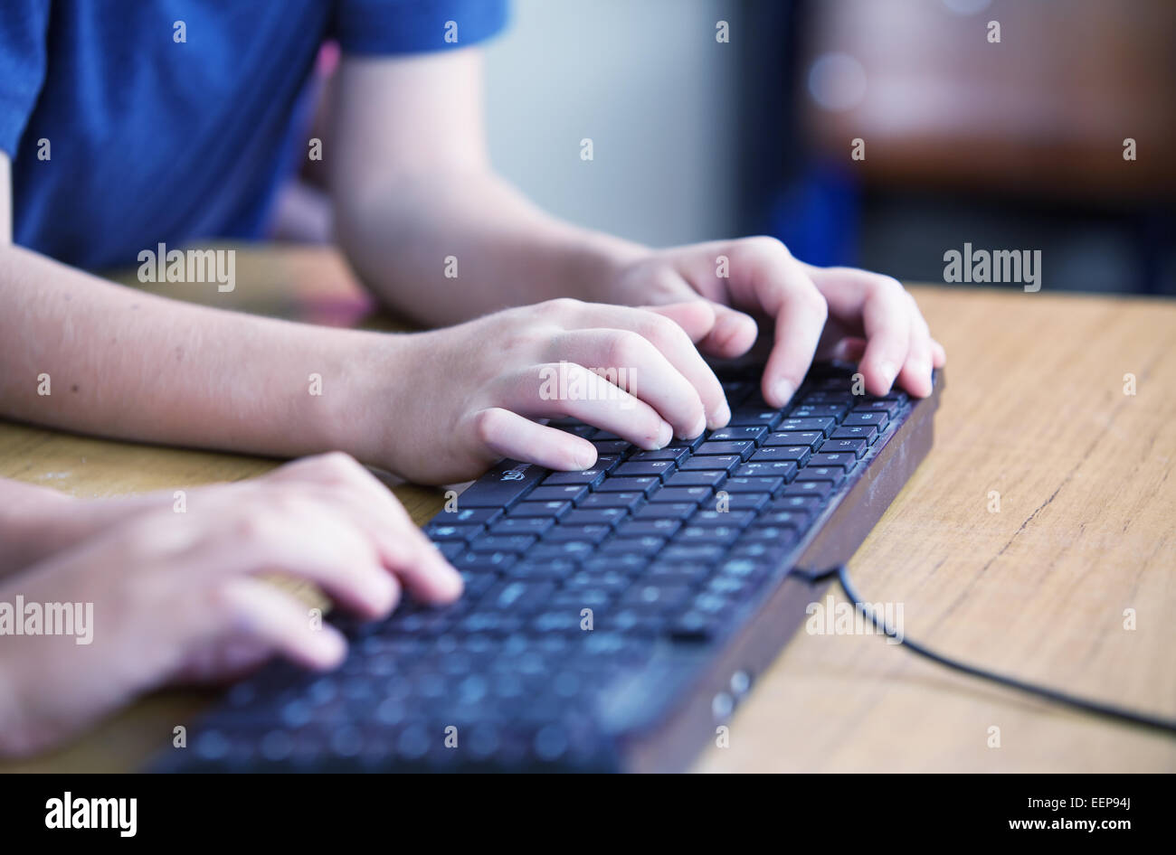Students typing on computer keyboard at school. Stock Photo