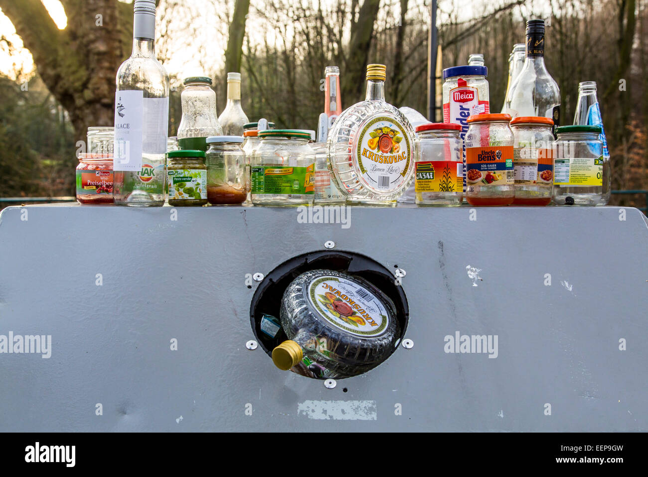 Recycling glass container,  crowded, bottles and glasses pile up and container next to the Stock Photo