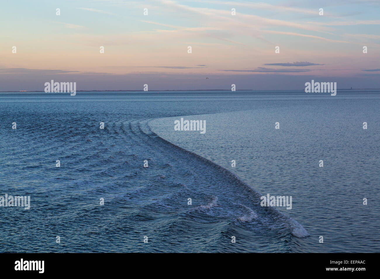 Wadden Sea, North Sea island Spiekeroog, ferry pulls a slight wave on the calm sea, at high tide Stock Photo