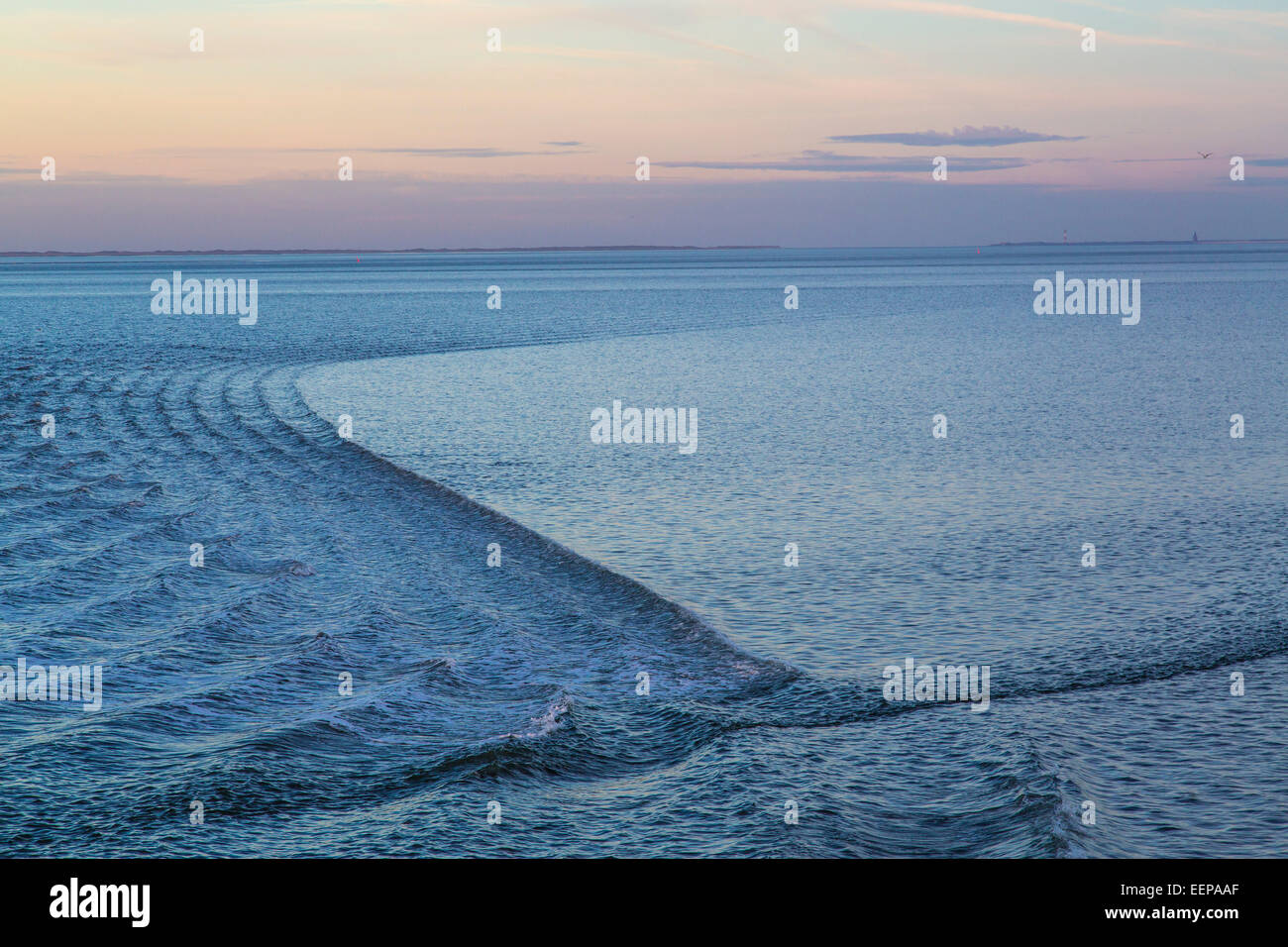 Wadden Sea, North Sea island Spiekeroog, ferry pulls a slight wave on the calm sea, at high tide Stock Photo
