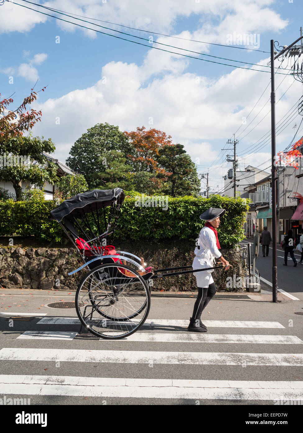 Man pulling a rickshaw in Kyoto street Stock Photo