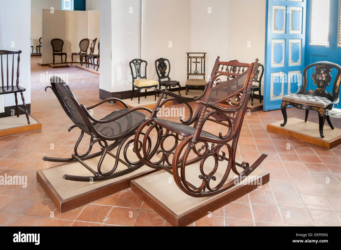 Room with antique wooden rocking chairs in the Colonial Art Museum (Museo del Arte Colonial) in Cathedral Square, Havana, Cuba Stock Photo