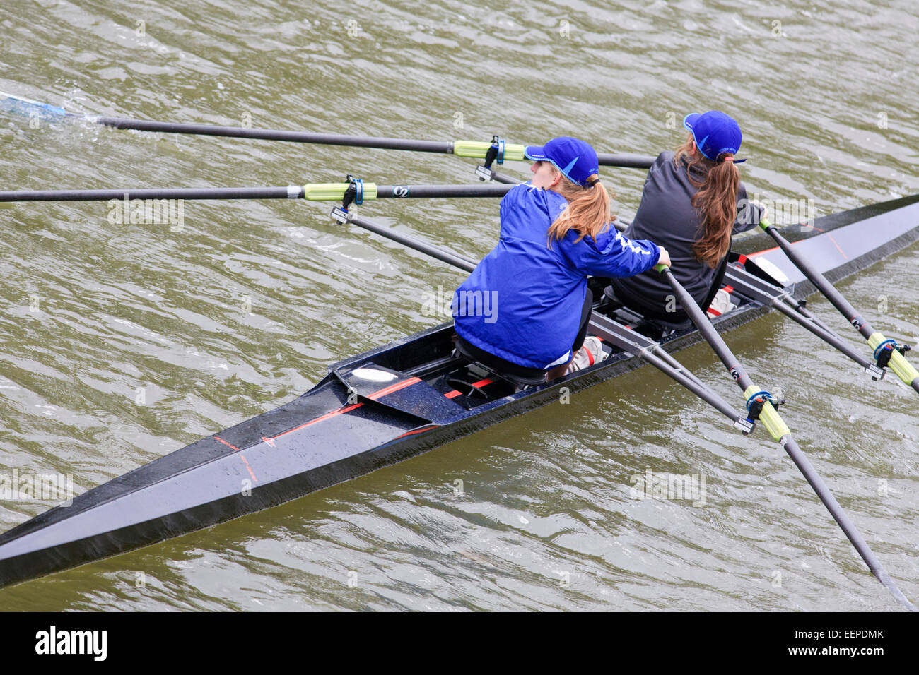 Two women on a rowing scull on a river. Stock Photo