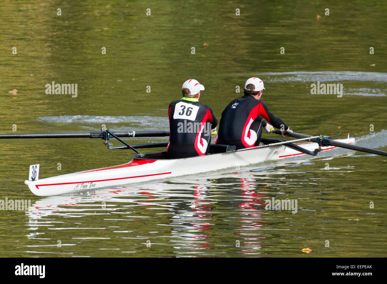 Two men on a rowing scull on a river. Stock Photo