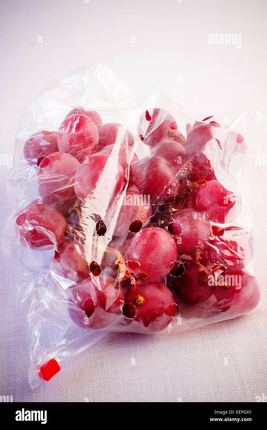 Grapes in a plastic bag on a white background Stock Photo Alamy