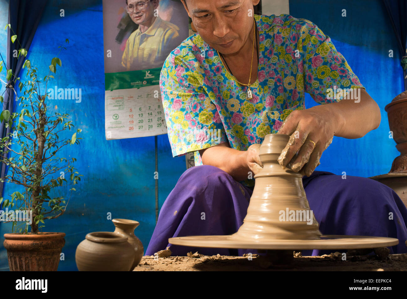 Ko Kred ceramics, Bangkok, Thailand. Potter turning clay vase on