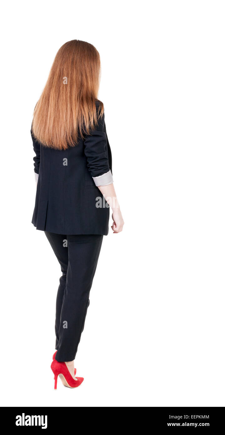 walking red head business woman. back view. going young girl in suit ...