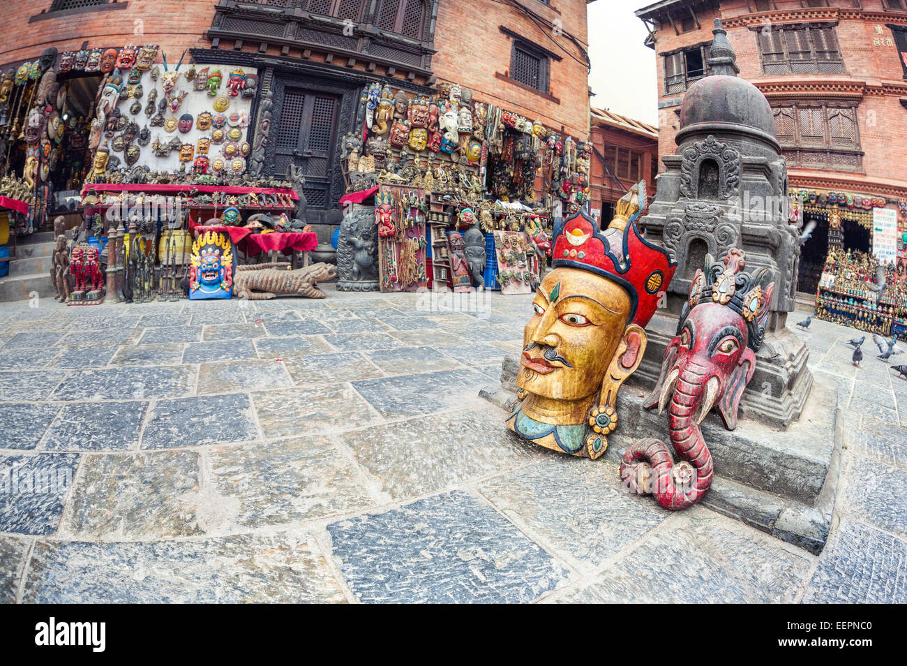Big wooden masks near souvenir shops on the square near Swayambhunath stupa in Kathmandu valley, Nepal Stock Photo