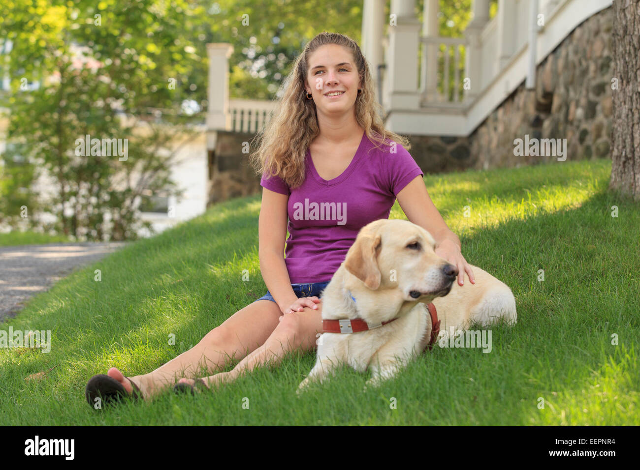 Woman with visual impairment relaxing with her service dog Stock Photo