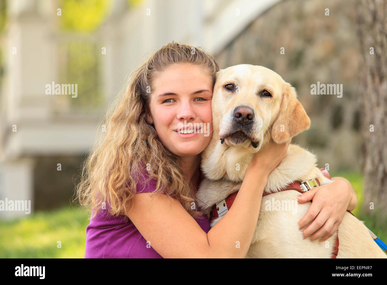 Woman with visual impairment hugging her service dog Stock Photo Alamy