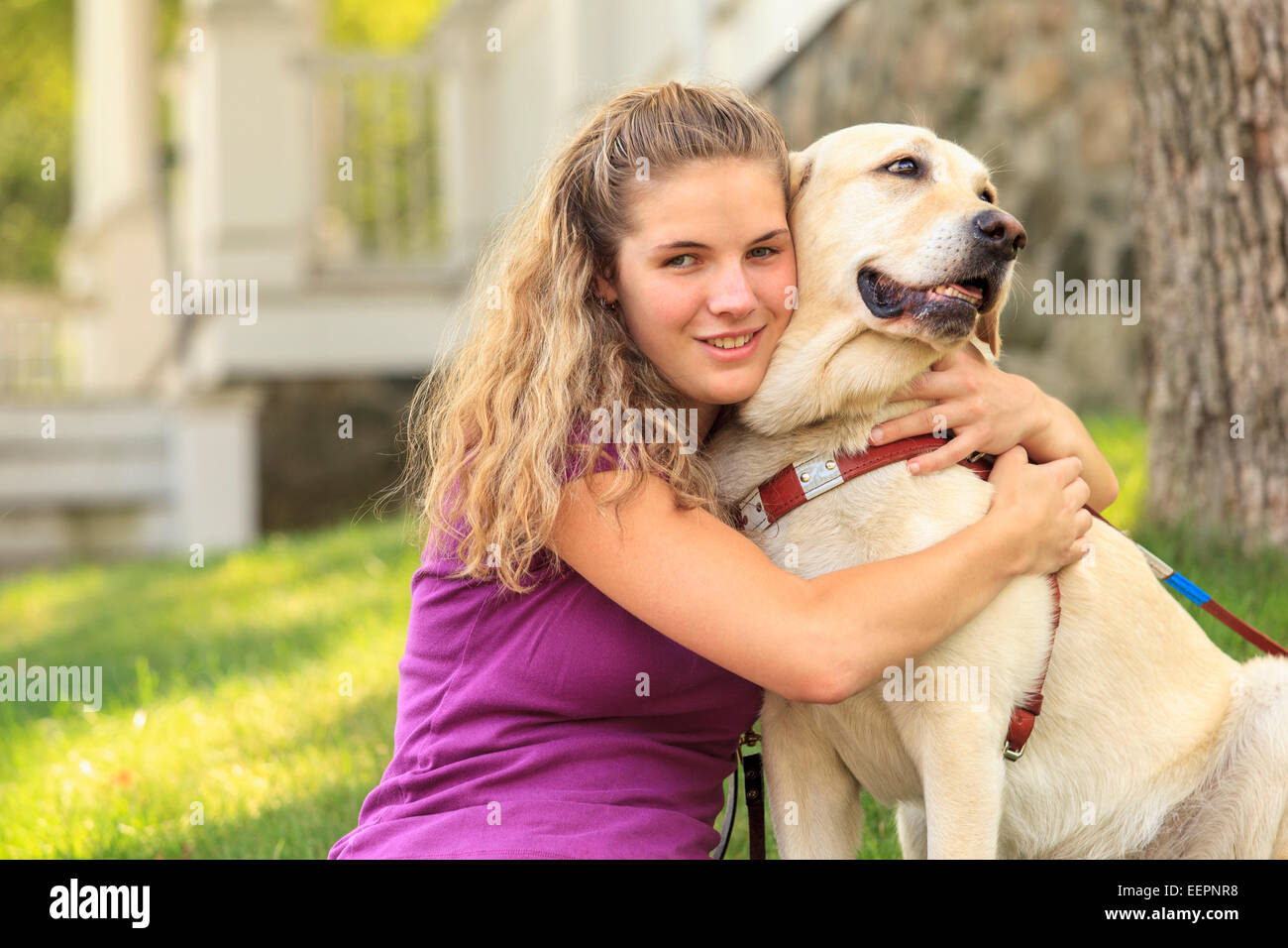 Woman with visual impairment hugging her service dog Stock Photo Alamy