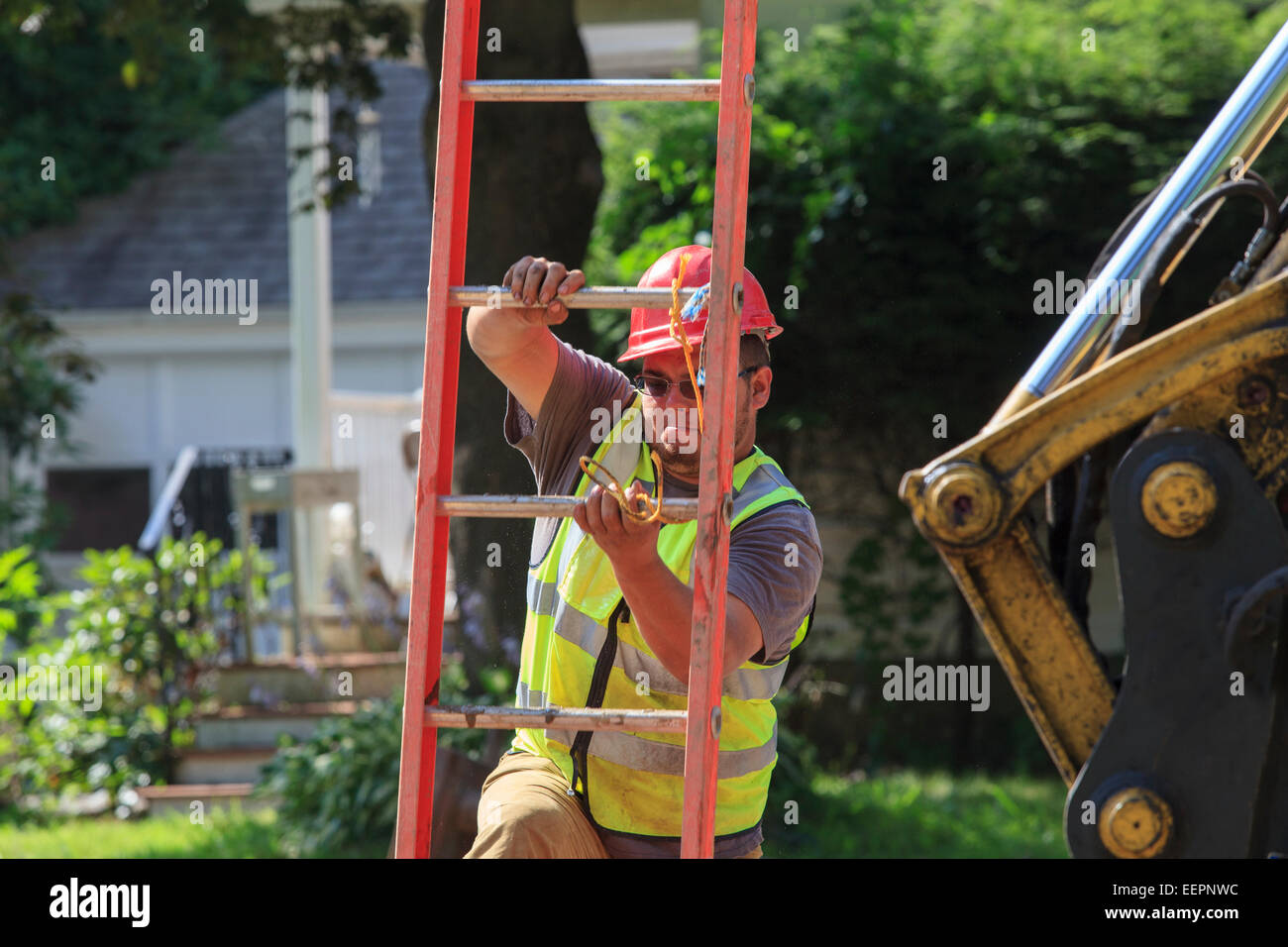 Construction worker climbing down ladder into shoring Stock Photo Alamy