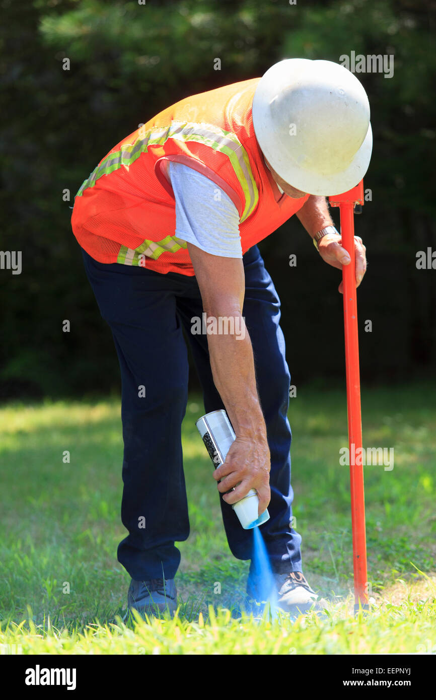 Construction supervisor marking valve location Stock Photo
