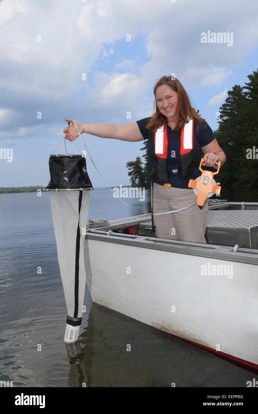 Water treatment engineer collecting samples using sieve Stock Photo Alamy