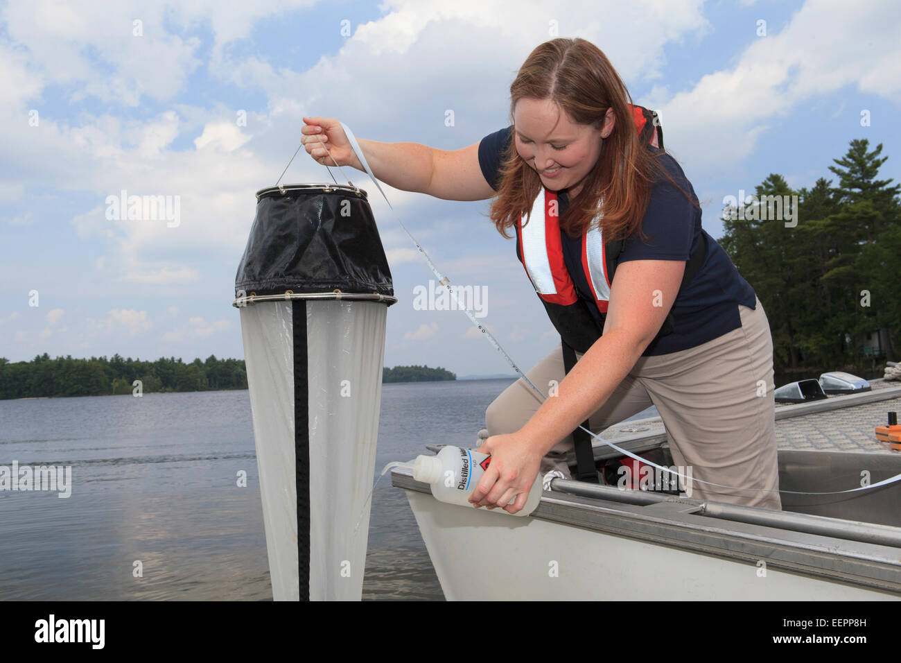 Water treatment engineer collecting samples using sieve Stock Photo Alamy