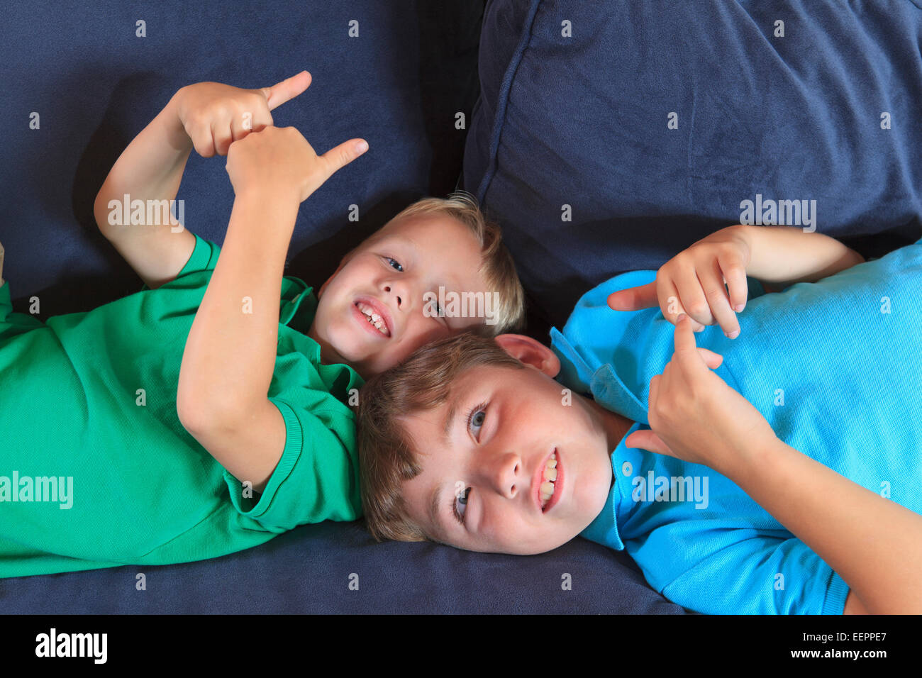 Boys with hearing impairments signing 'game, play' in American sign