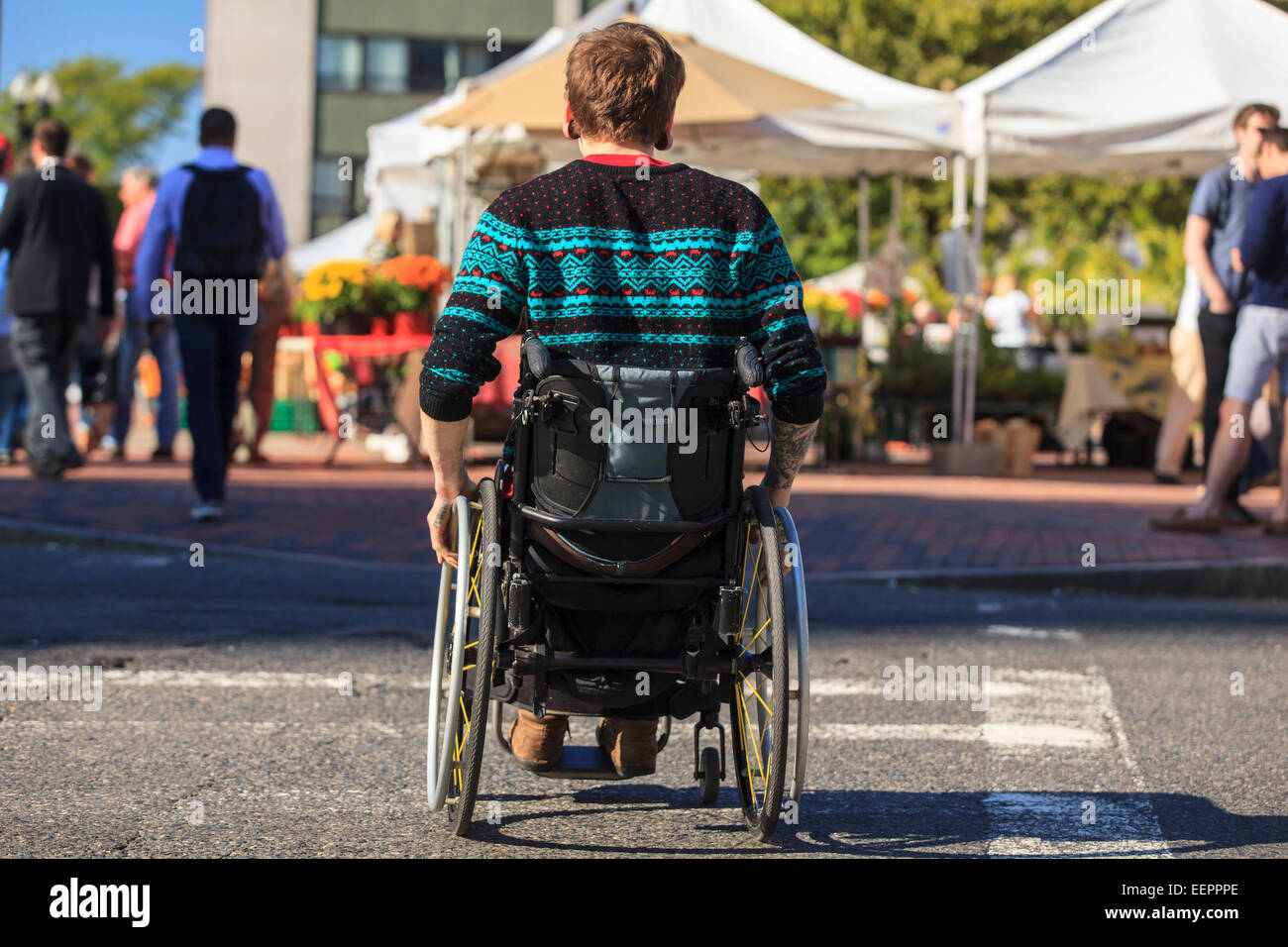 Trendy man with a spinal cord injury in wheelchair at a city outdoor