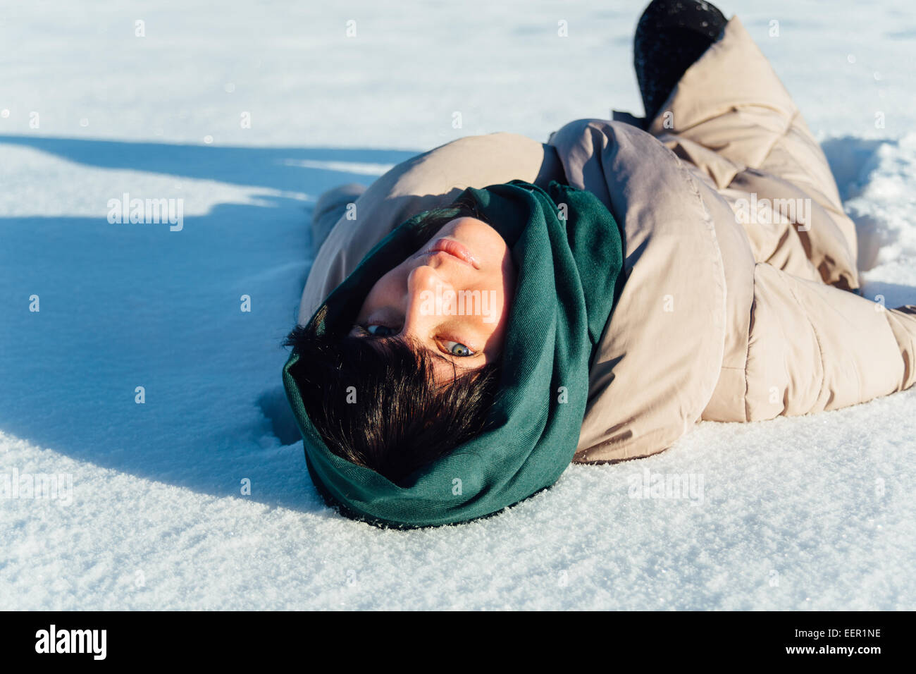 girl lying on the snow and smiling Stock Photo