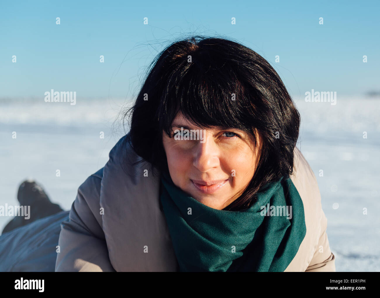 girl lying on the snow Stock Photo