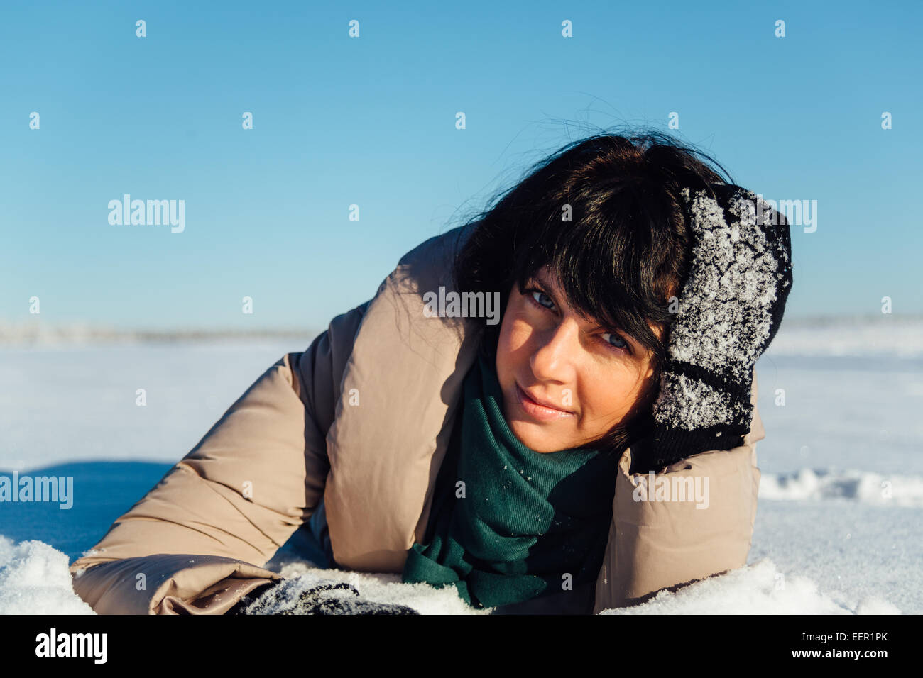 girl lying on the snow Stock Photo