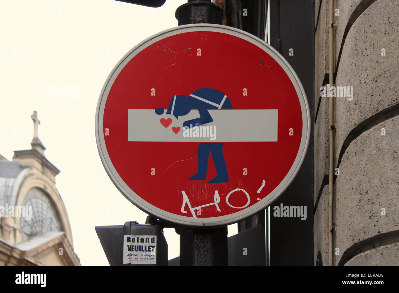 A sticker representing a sailor was stuck on a road sign in Paris (France). Stock Photo