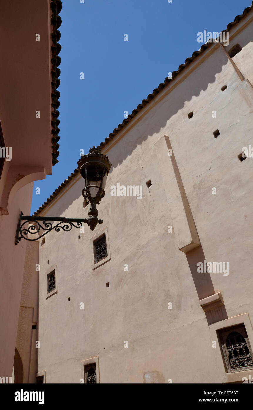 Ornate traditional street lamp light on a wall in Marrakesh Morocco against a blue sky Stock Photo