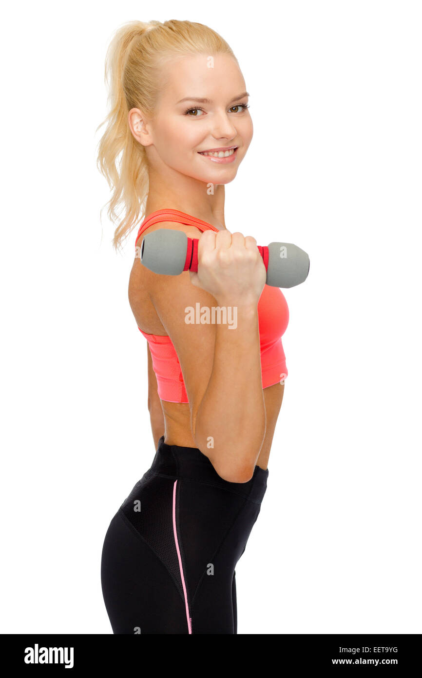 smiling beautiful sporty woman with dumbbell Stock Photo