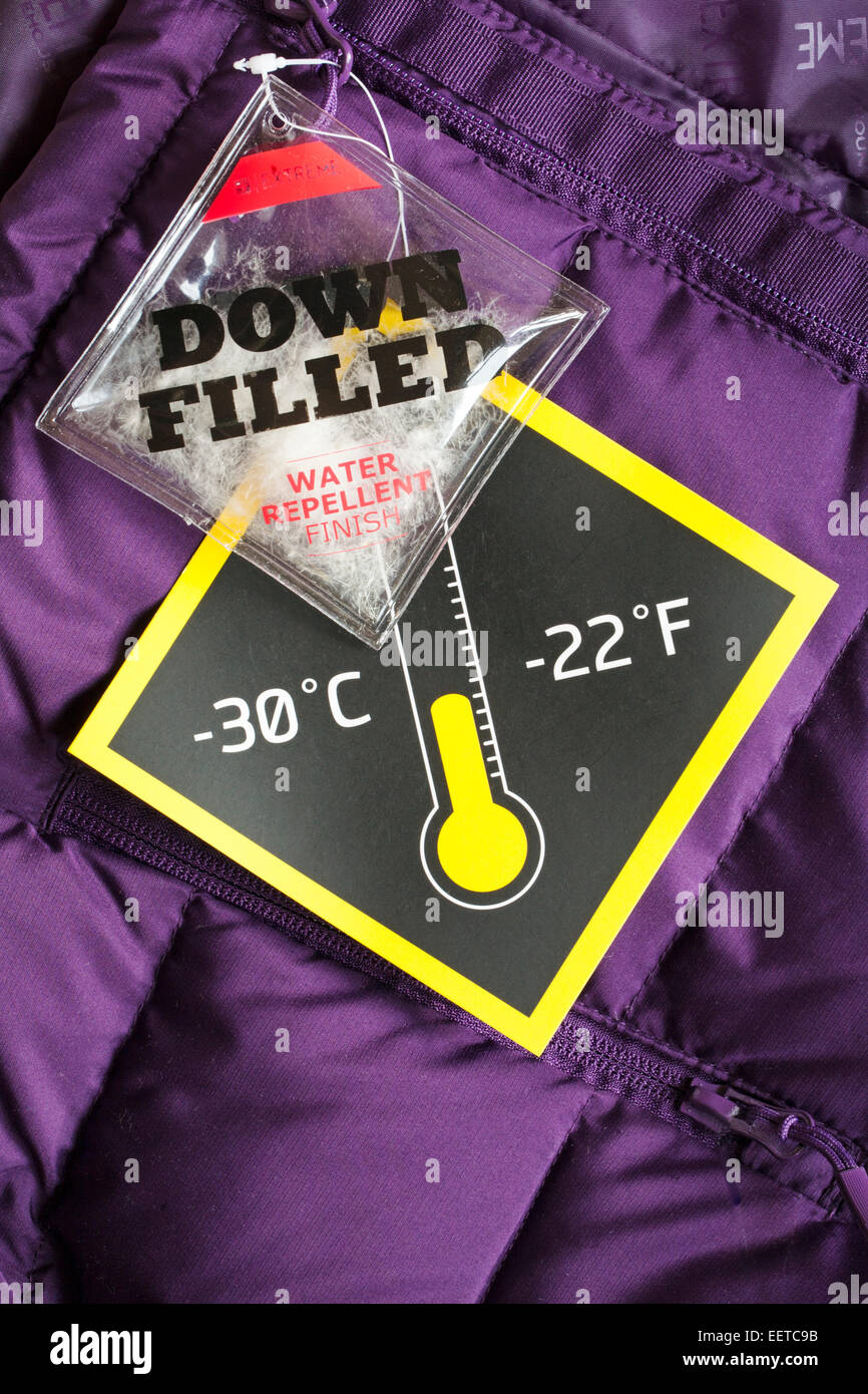 Down Filled Water repellent and temperature tag labels on purple down jacket Stock Photo