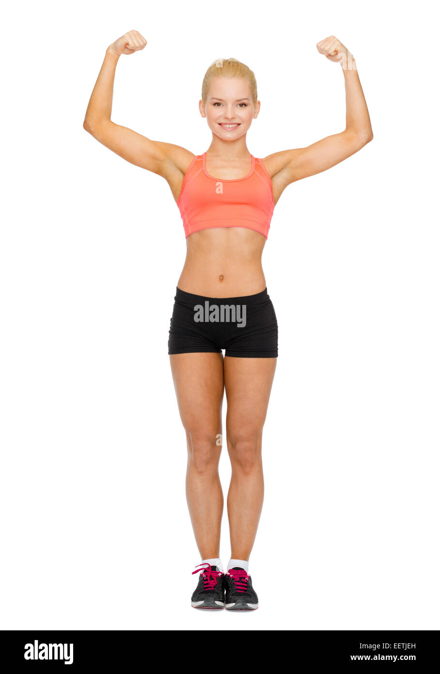 smiling sporty woman flexing her biceps Stock Photo - Alamy